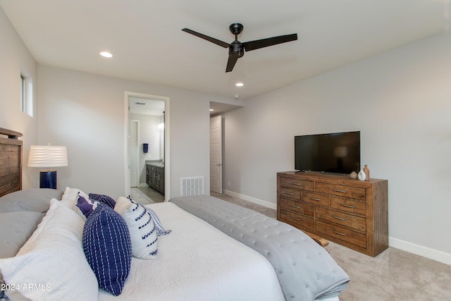 carpeted bedroom featuring ensuite bathroom and ceiling fan