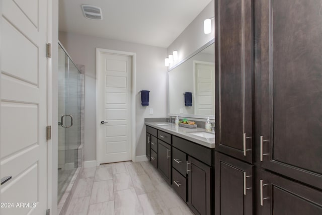 bathroom with vanity and an enclosed shower