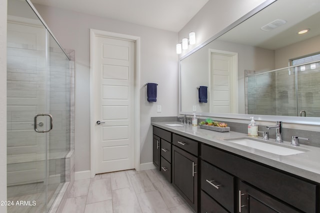 bathroom featuring vanity and an enclosed shower