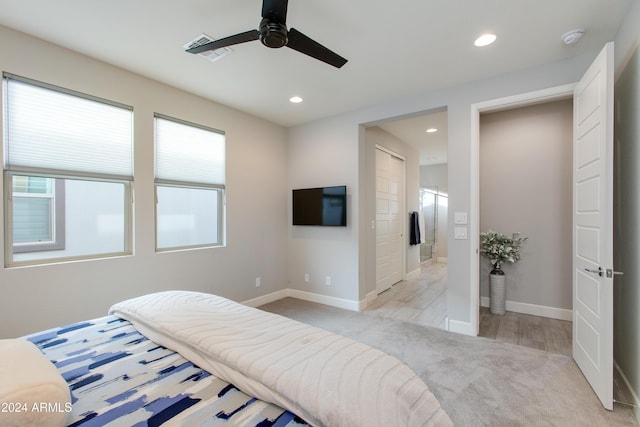 carpeted bedroom featuring ensuite bathroom and ceiling fan