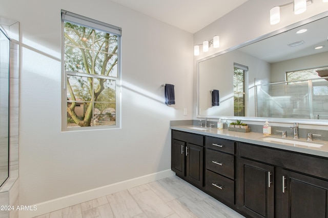 bathroom with plenty of natural light, vanity, and a shower with shower door