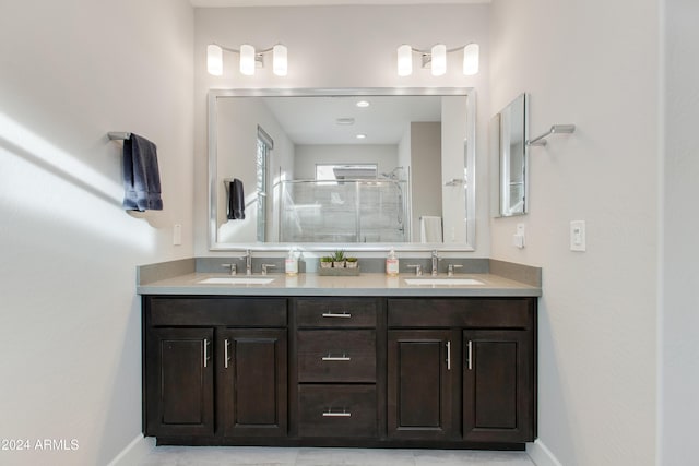 bathroom featuring vanity and an enclosed shower