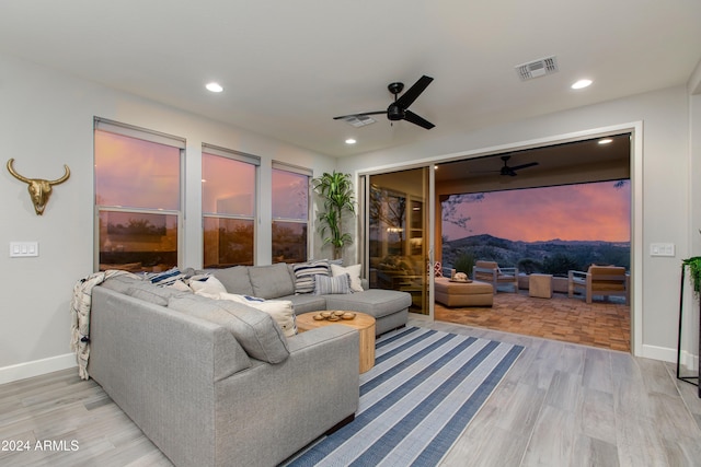 living room with ceiling fan and light hardwood / wood-style floors