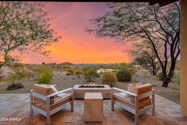 patio terrace at dusk featuring an outdoor fire pit