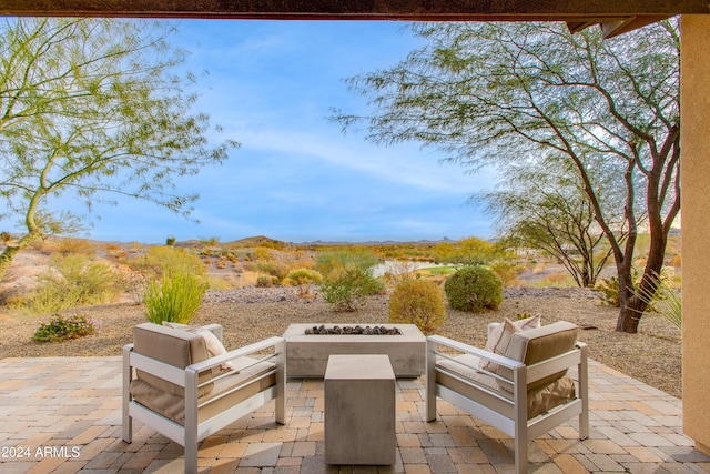 view of patio / terrace with an outdoor living space with a fire pit