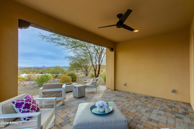 view of patio with an outdoor living space and ceiling fan