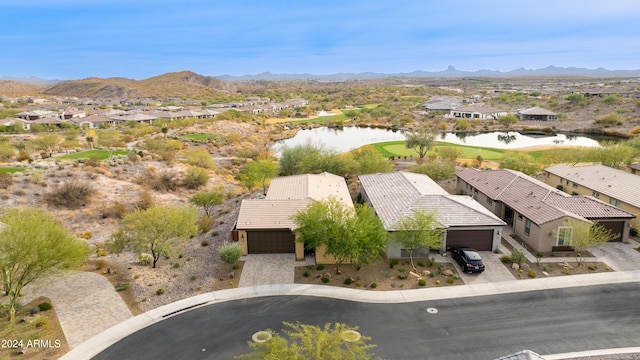 drone / aerial view featuring a water and mountain view