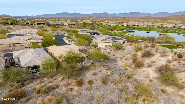 drone / aerial view with a water and mountain view