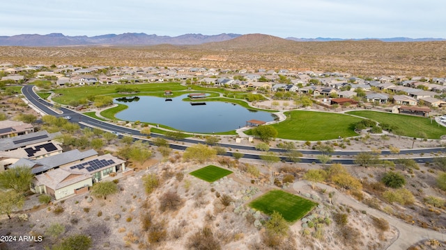 birds eye view of property with a water and mountain view