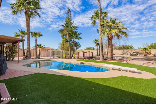 view of swimming pool featuring a fenced backyard, a lawn, a fenced in pool, and a patio