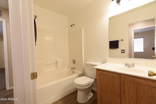 full bathroom with shower / bathing tub combination, hardwood / wood-style floors, vanity, and toilet