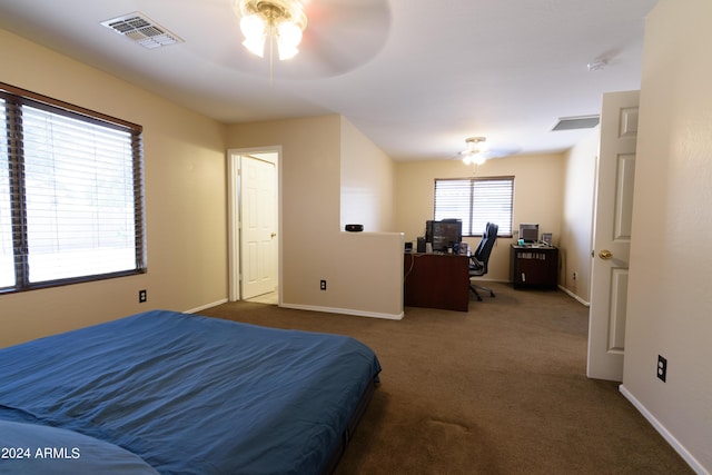 bedroom featuring dark carpet and ceiling fan