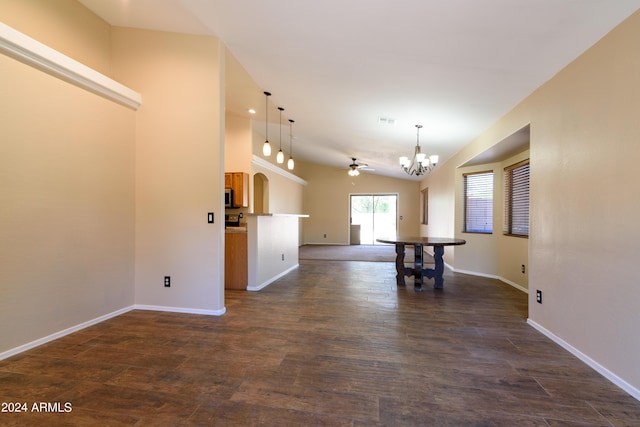 interior space featuring ceiling fan with notable chandelier, dark wood-type flooring, and vaulted ceiling