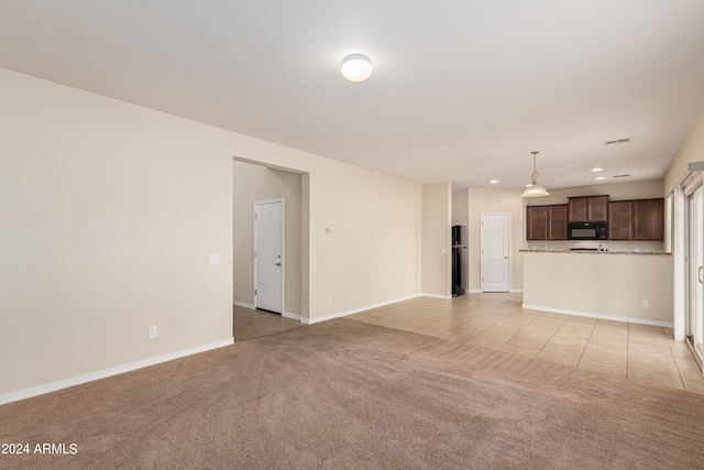 unfurnished living room featuring light colored carpet