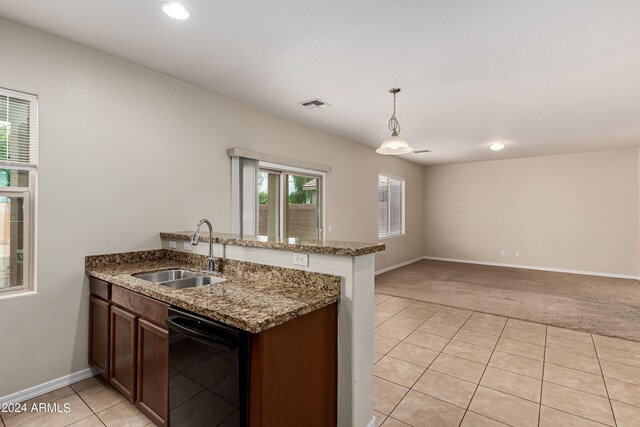 kitchen featuring light stone counters, kitchen peninsula, black appliances, pendant lighting, and light tile patterned flooring