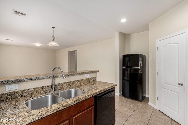 kitchen with light stone counters, hanging light fixtures, black appliances, light tile patterned floors, and sink