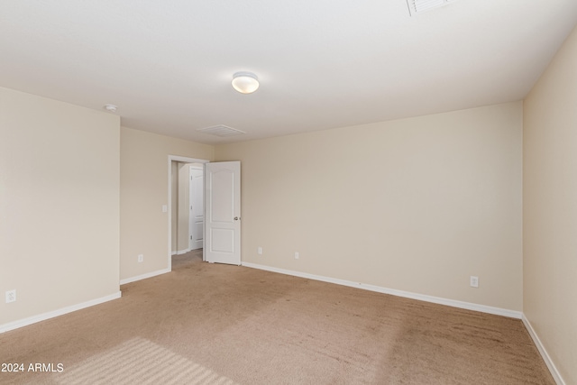 spare room with light colored carpet