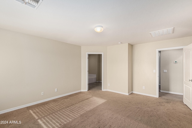 unfurnished bedroom featuring light carpet