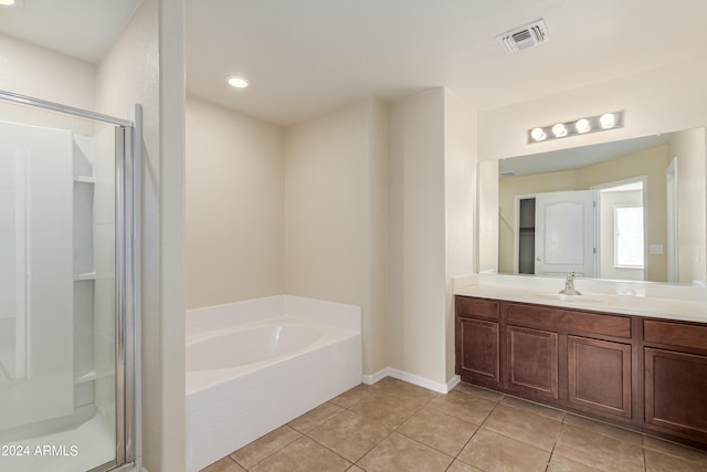 bathroom with plus walk in shower, tile patterned floors, and vanity