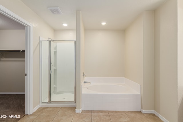 bathroom with tile patterned floors and separate shower and tub