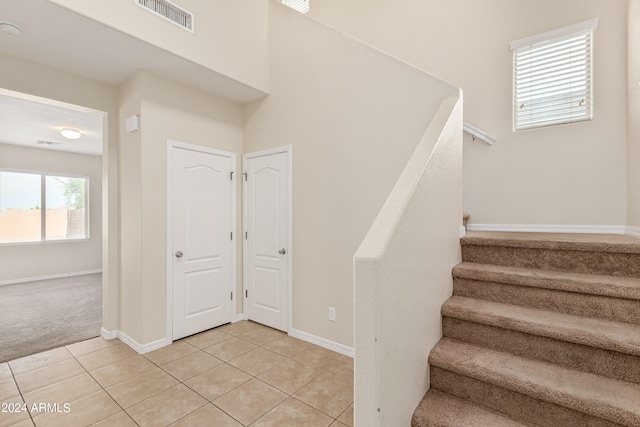 stairway with light tile patterned flooring