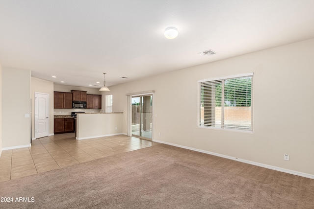 unfurnished living room with plenty of natural light and light tile patterned floors