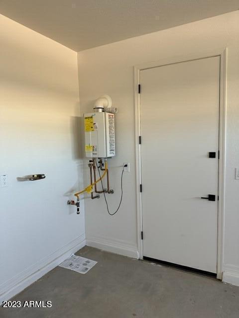 utility room with tankless water heater