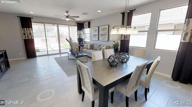 dining room featuring ceiling fan with notable chandelier and light tile patterned floors