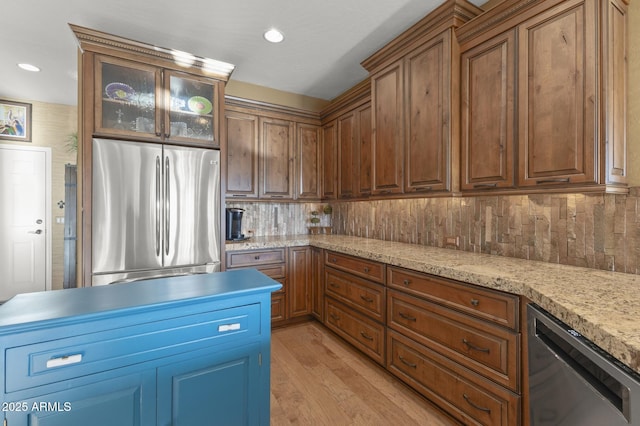 kitchen featuring light wood-type flooring, wine cooler, stainless steel refrigerator, and decorative backsplash