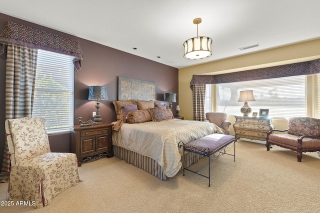 carpeted bedroom featuring multiple windows