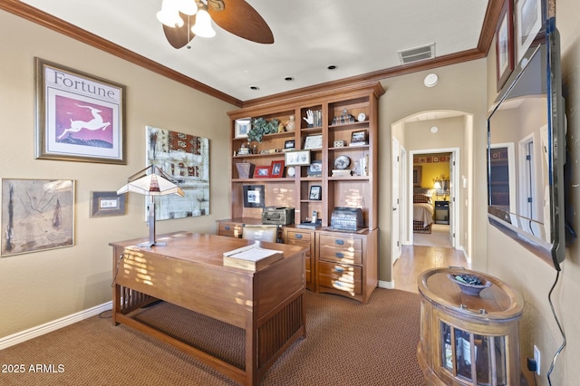 carpeted office space with crown molding and ceiling fan