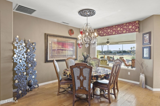 dining area with a chandelier and light hardwood / wood-style flooring