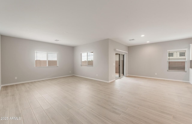 unfurnished room with baseboards, recessed lighting, and light wood-style flooring