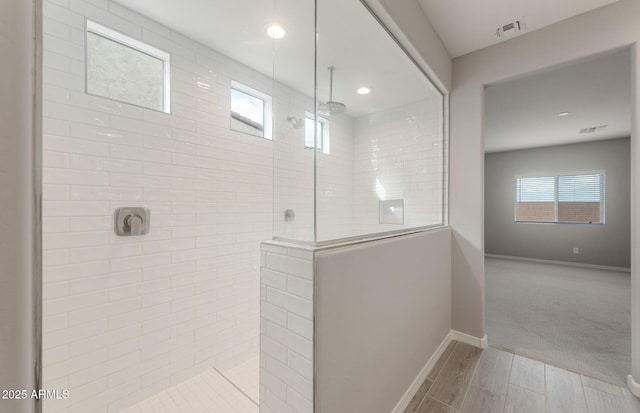 bathroom with baseboards, visible vents, recessed lighting, walk in shower, and wood finished floors