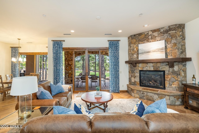 1734 E Mossy Oak Ct Unit 2, Flagstaff, AZ 86005 - living area with visible vents, wood finished floors, a stone fireplace, and recessed lighting