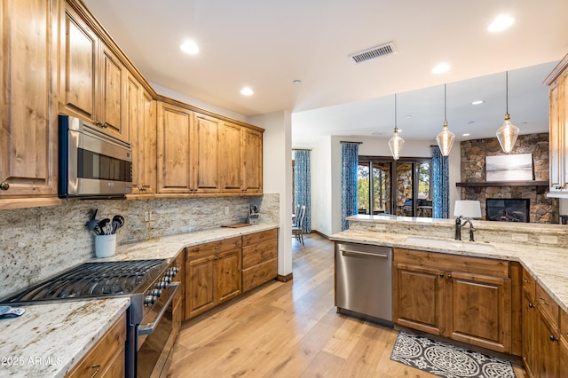 1734 E Mossy Oak Ct Unit 2, Flagstaff, AZ 86005 - kitchen with brown cabinets, a sink, stainless steel appliances, visible vents, and tasteful backsplash