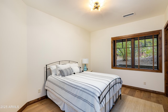 1734 E Mossy Oak Ct Unit 2, Flagstaff, AZ 86005 - bedroom with wood finished floors, visible vents, and baseboards