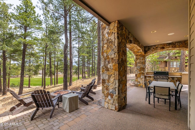 1734 E Mossy Oak Ct Unit 2, Flagstaff, AZ 86005 - view of patio featuring outdoor dining area, an outdoor fire pit, area for grilling, and an outdoor kitchen