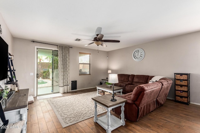 living room featuring ceiling fan and wood-type flooring