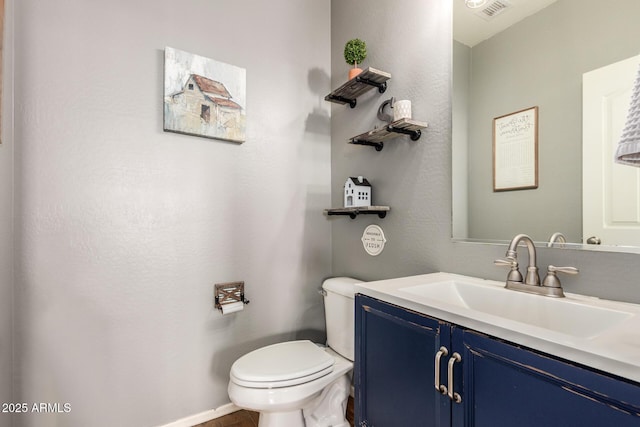 bathroom featuring vanity and toilet