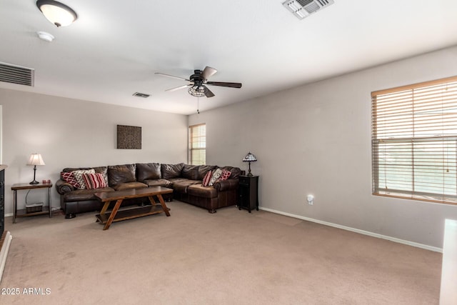 carpeted living room with ceiling fan