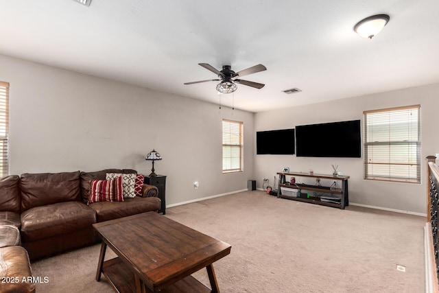 carpeted living room with ceiling fan