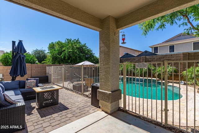 view of patio with a fenced in pool and an outdoor living space with a fire pit