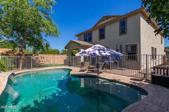 view of swimming pool with pool water feature and a patio area