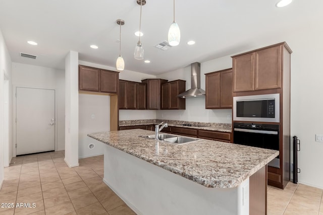 6331 W Desert Blossom Way, Florence, AZ 85132 - kitchen featuring stainless steel appliances, wall chimney exhaust hood, a sink, hanging light fixtures, and light stone counters