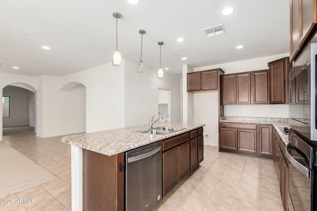 6331 W Desert Blossom Way, Florence, AZ 85132 - kitchen featuring dishwasher, a sink, black oven, light tile patterned flooring, and arched walkways