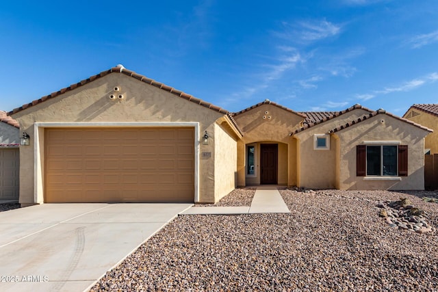 6331 W Desert Blossom Way, Florence, AZ 85132 - mediterranean / spanish home featuring concrete driveway, stucco siding, a garage, and a tile roof