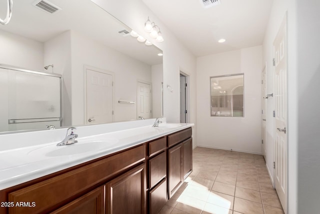 6331 W Desert Blossom Way, Florence, AZ 85132 - full bath featuring double vanity, tile patterned floors, an enclosed shower, recessed lighting, and baseboards