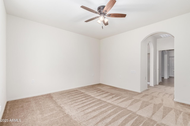 6331 W Desert Blossom Way, Florence, AZ 85132 - unfurnished room featuring arched walkways, light colored carpet, ceiling fan, and baseboards