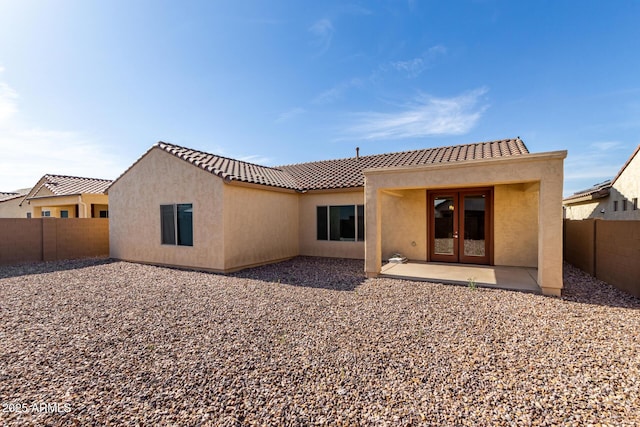 6331 W Desert Blossom Way, Florence, AZ 85132 - back of house featuring stucco siding, a tile roof, a fenced backyard, and a patio